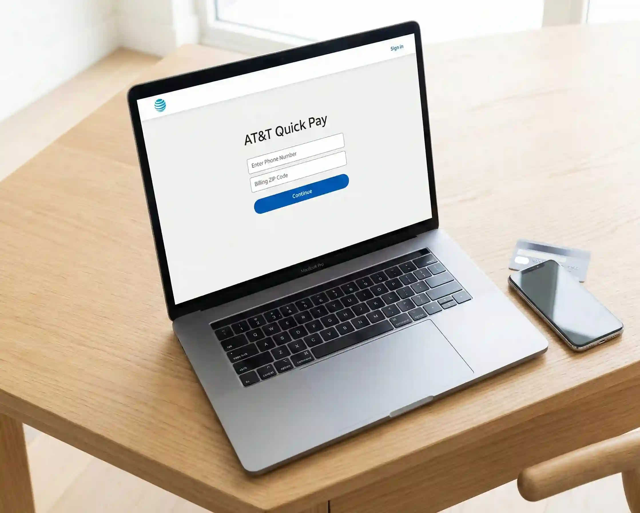 A top-down view of a laptop displaying the simple AT&T FastPay web interface requiring only a phone number and ZIP code to pay without logging in.